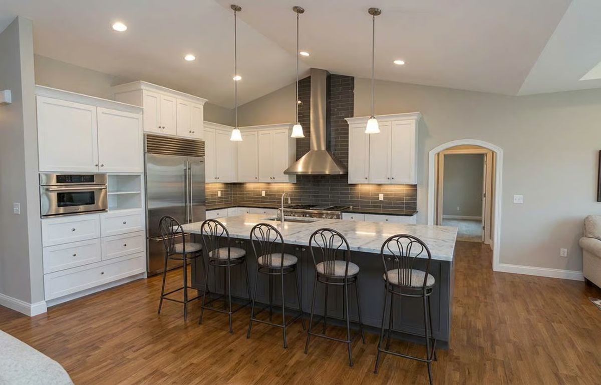 Marble Island and Dark Stools Define This Kitchen's Contrast