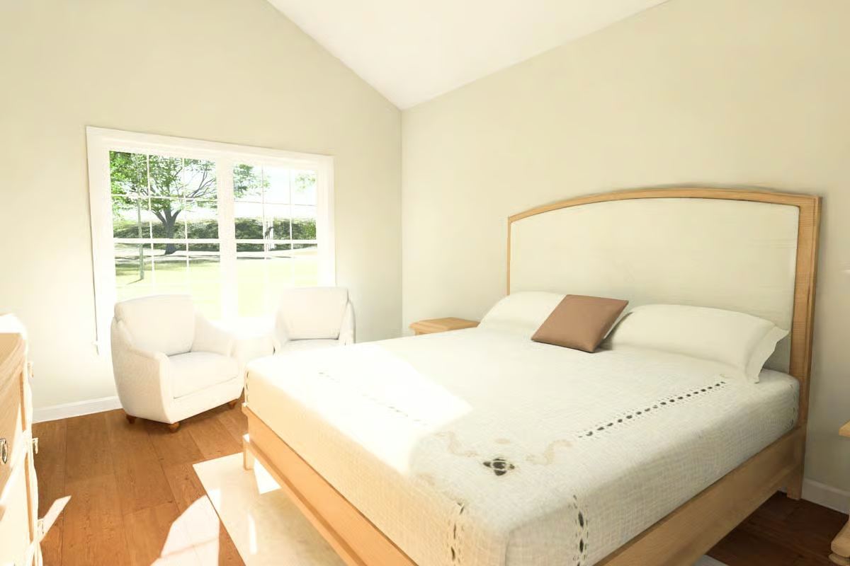 Serene Bedroom with Upholstered Headboard and White Armchair