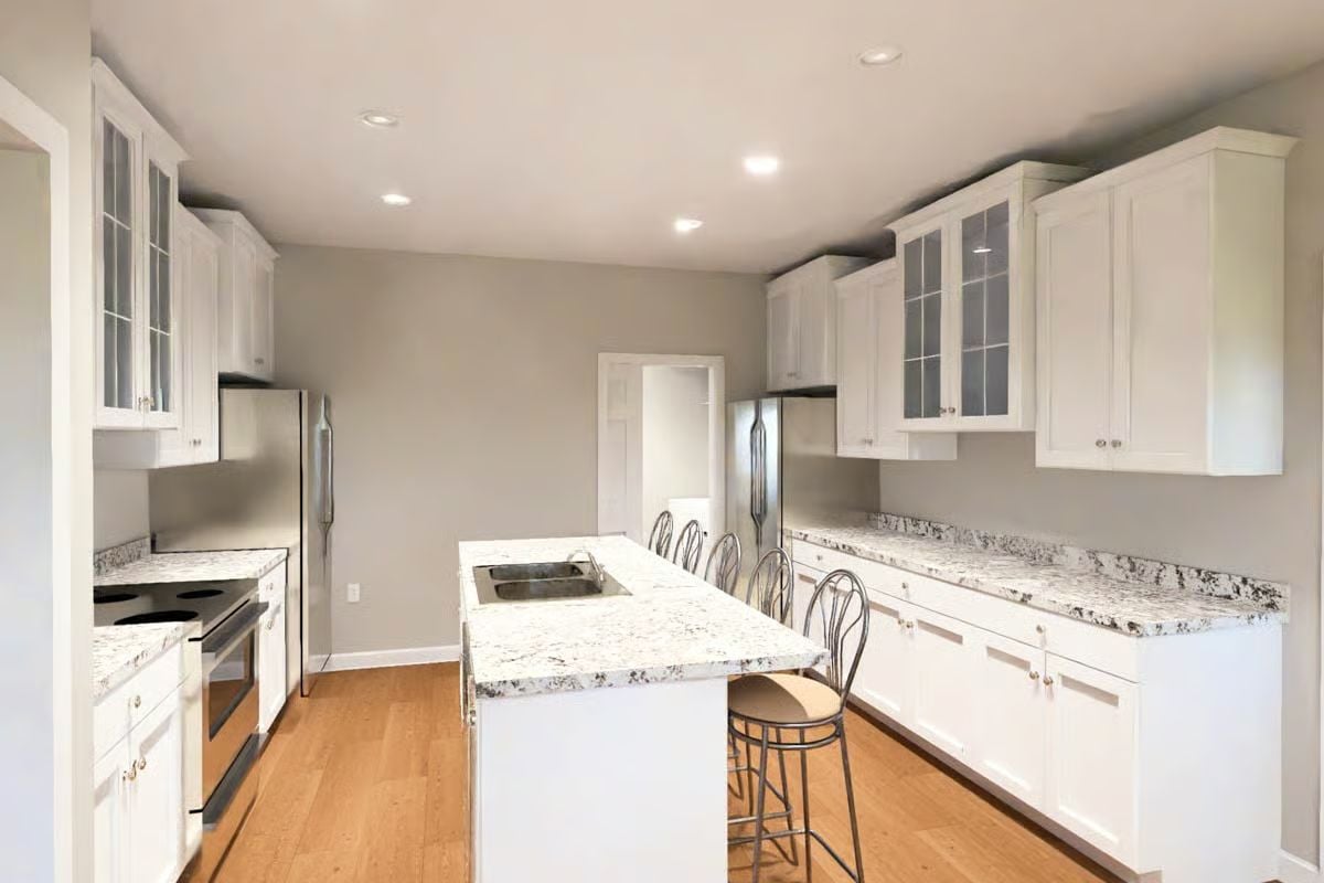 White Shaker Cabinets and Speckled Granite in Galley Kitchen