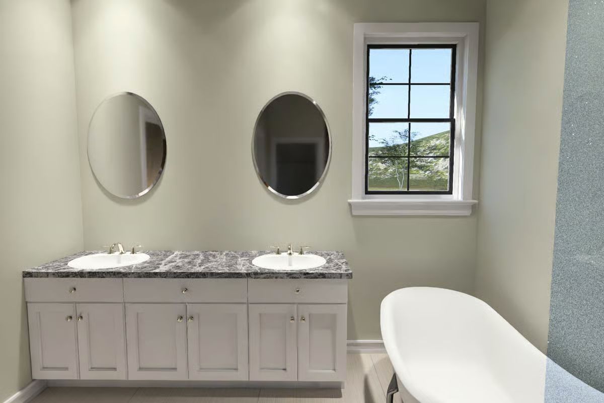 Dual Vanity Bathroom with Oval Mirrors and Marble Countertop