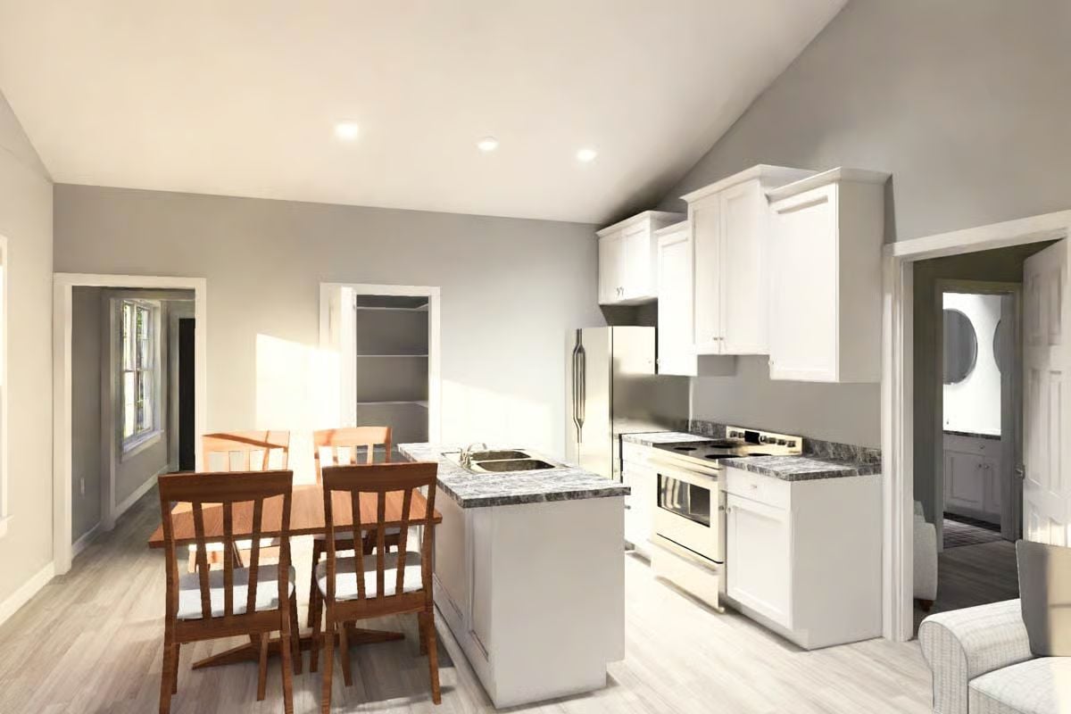 Open-Concept Kitchen and Dining Area with White Cabinetry and Wood Seating