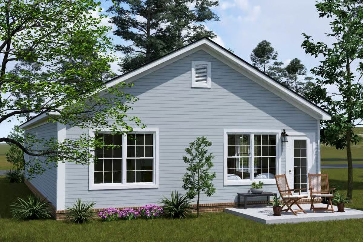 Pale Blue Cottage Exterior with White Trim and Outdoor Patio