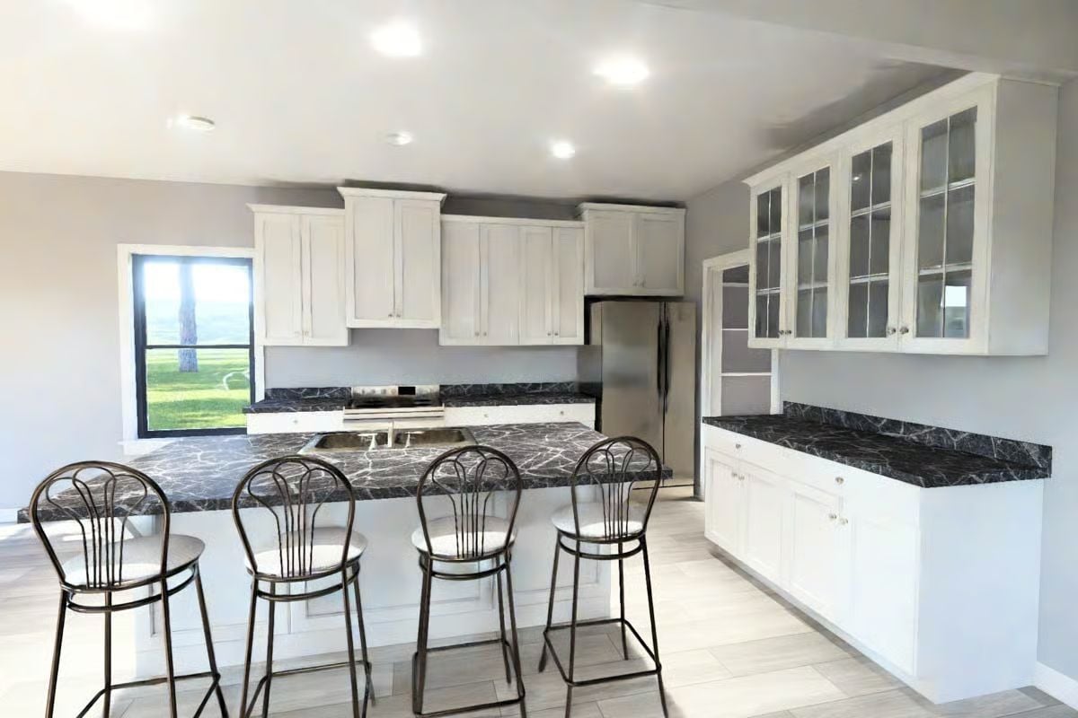 White Shaker Cabinetry with Black Marble Countertops and Island Seating