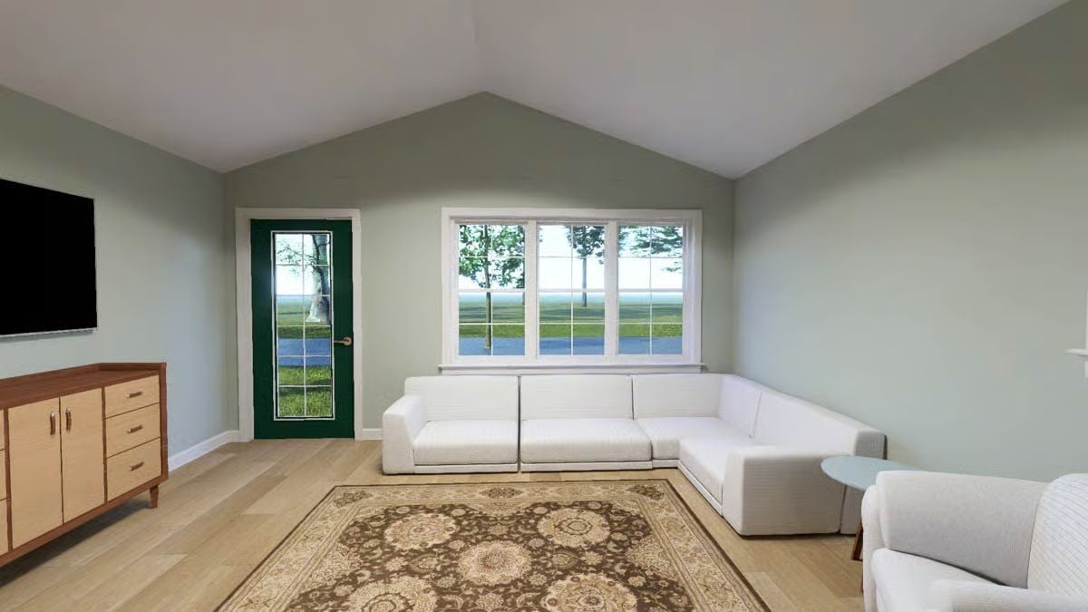 Vaulted Ceilings and a White Sectional in a Sage Green Living Room