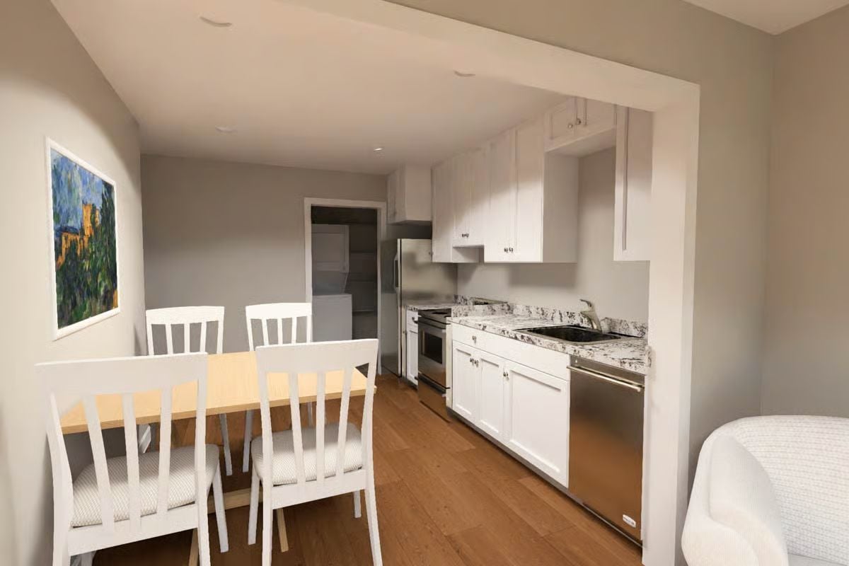 White Shaker Cabinets and Granite Counters Define a Galley Kitchen