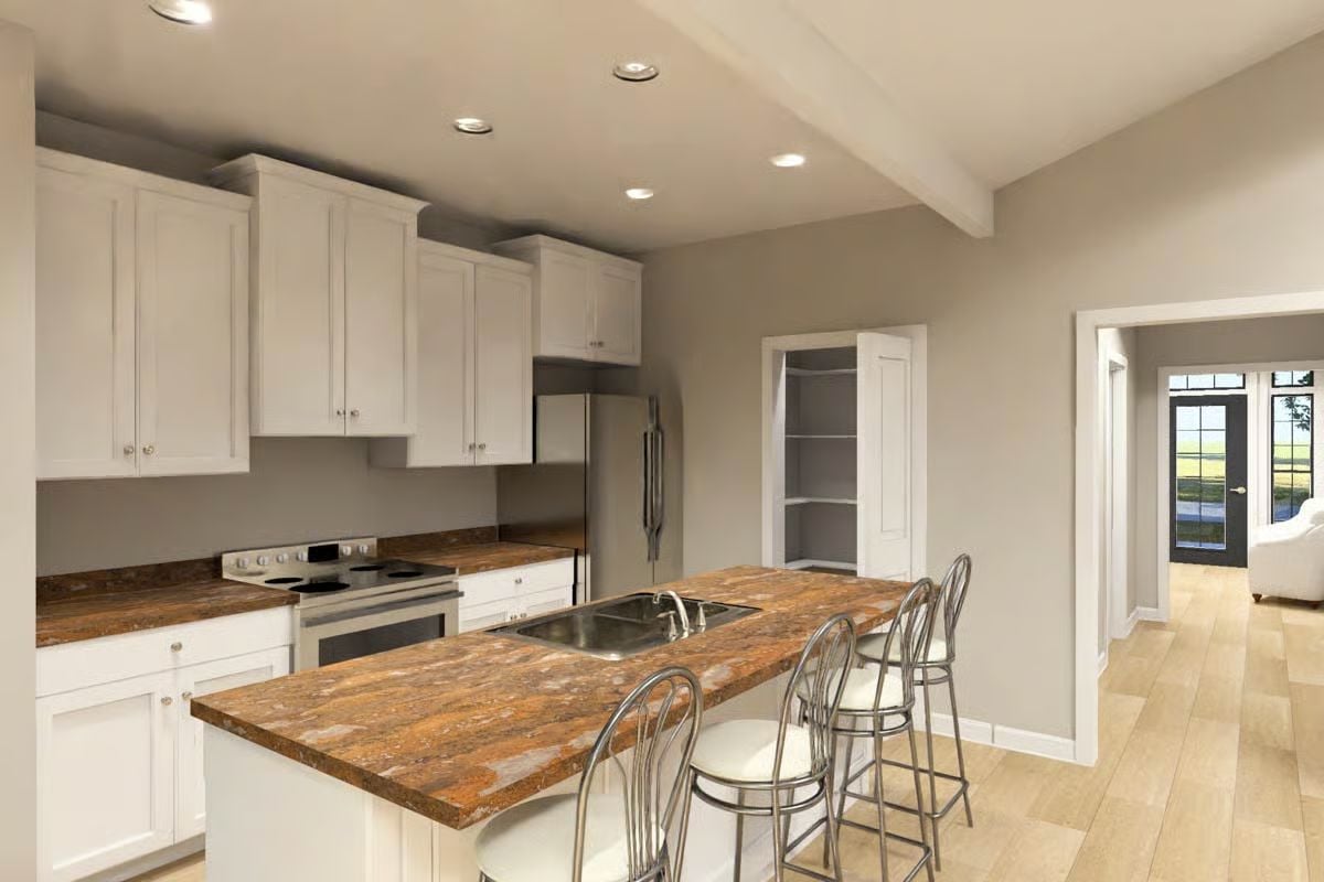 White Cabinets and Granite Island Anchor an Open-Plan Kitchen