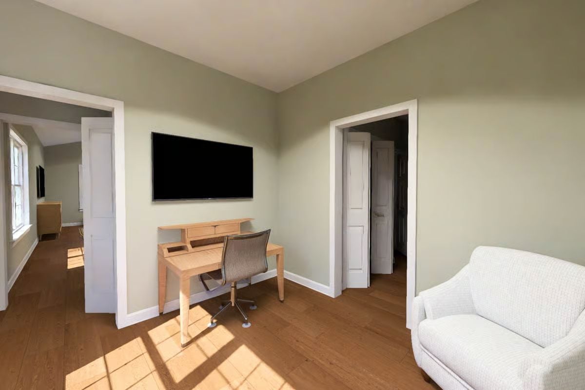 Sage Walls and Warm Wood Floors Define This Sun-Drenched Home Office