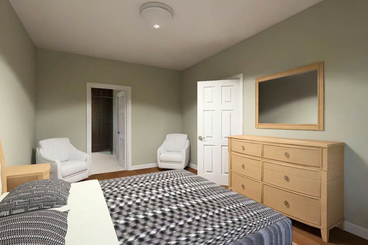Warm Wood Tones and Paired Armchairs Give This Bedroom a Quiet, Restful Character