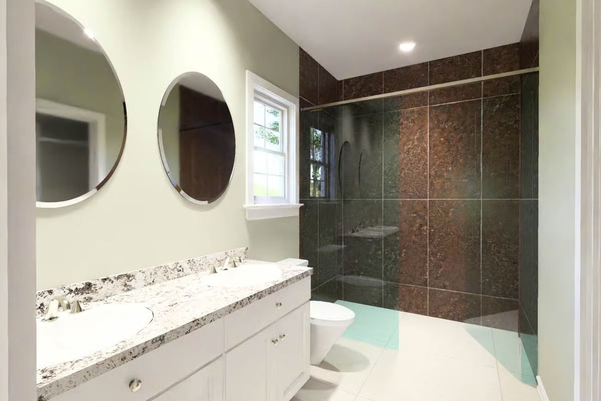Double Vanity and Dark Stone Tile Give This Primary Bathroom Quiet Confidence