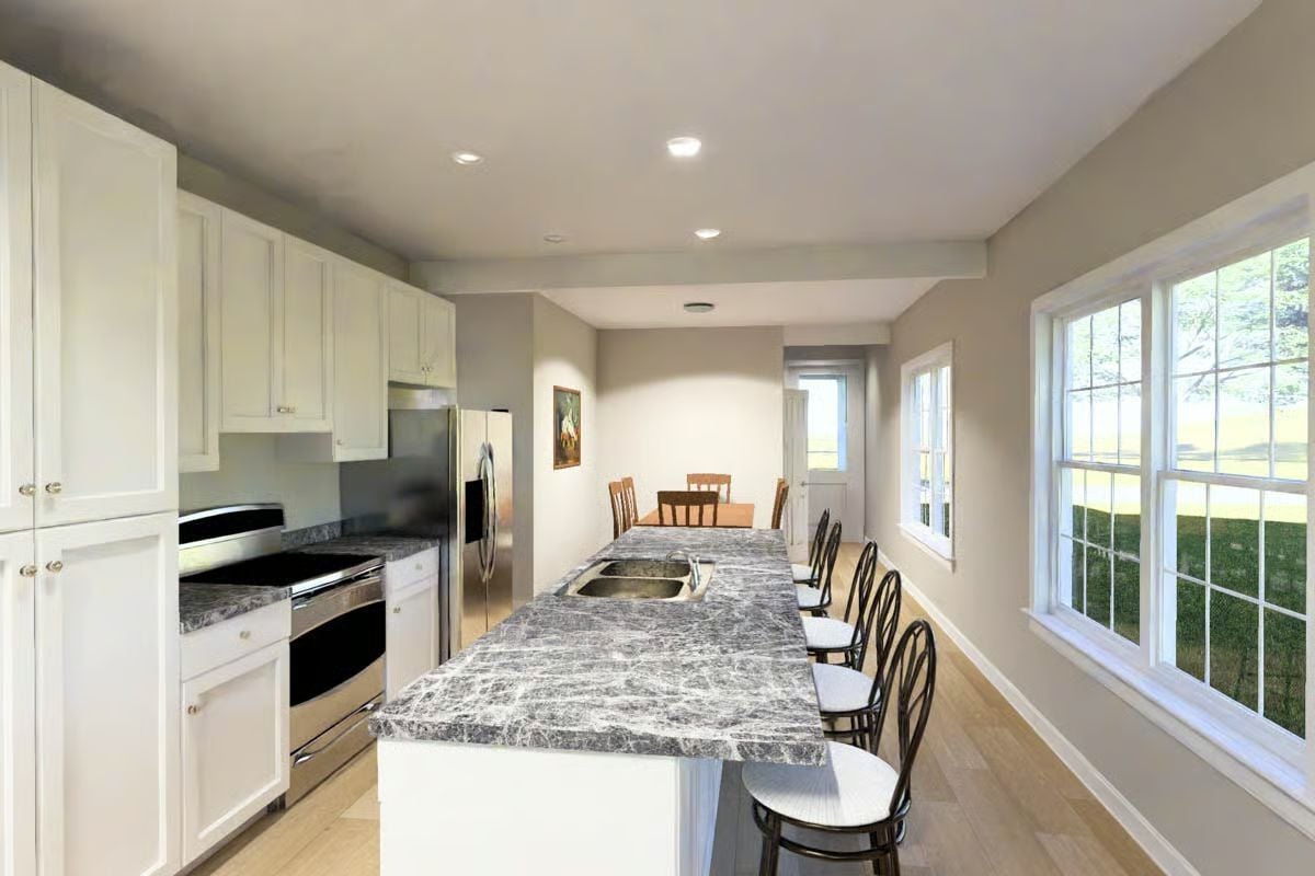 Dark Marble Island and White Cabinetry Define a Long Galley Kitchen