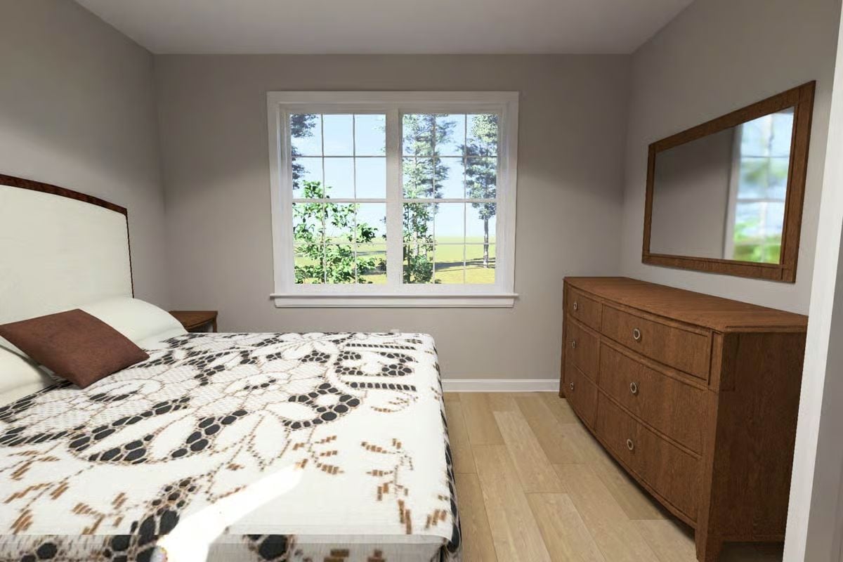 Warm Oak Dresser and Patterned Bedding Ground a Soft Gray Bedroom