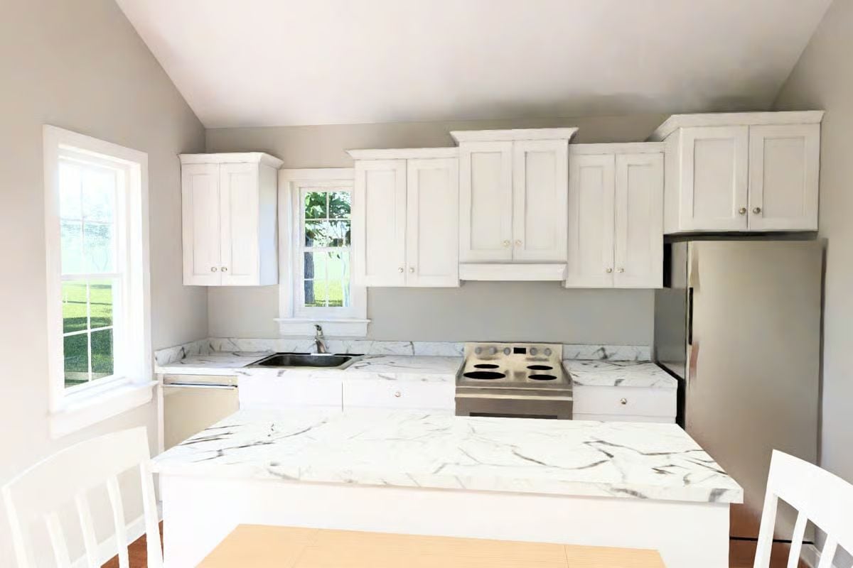 Marble Countertops and White Cabinetry Keep This Cottage Kitchen Crisp