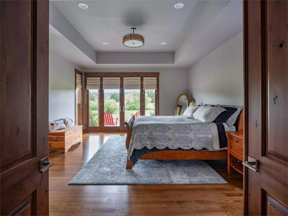 Sleigh Bed and French Doors Open a Master Suite Toward Open Fields