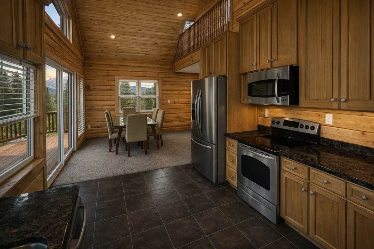 Natural Wood Kitchen with Stainless Appliances and Dining Alcove Beyond