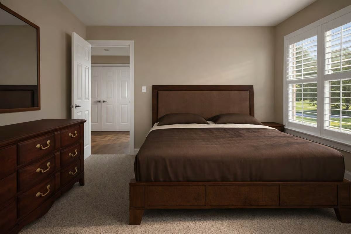 Primary Bedroom with Dark Wood Furniture and Plantation Shutters