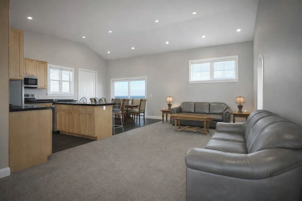 Leather Sofas and Recessed Lighting Bring the Open Living Area Together