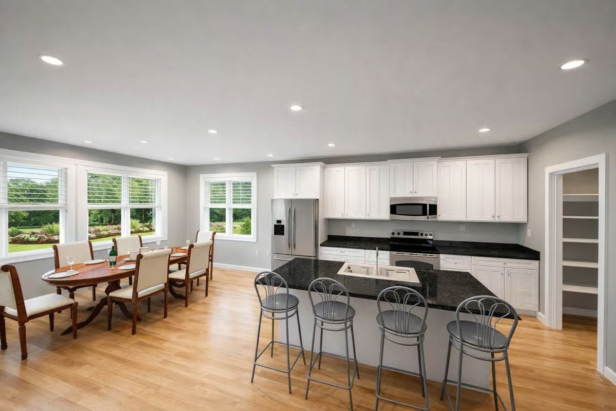 Dark Granite Counters Anchor an Open Kitchen and Dining Space