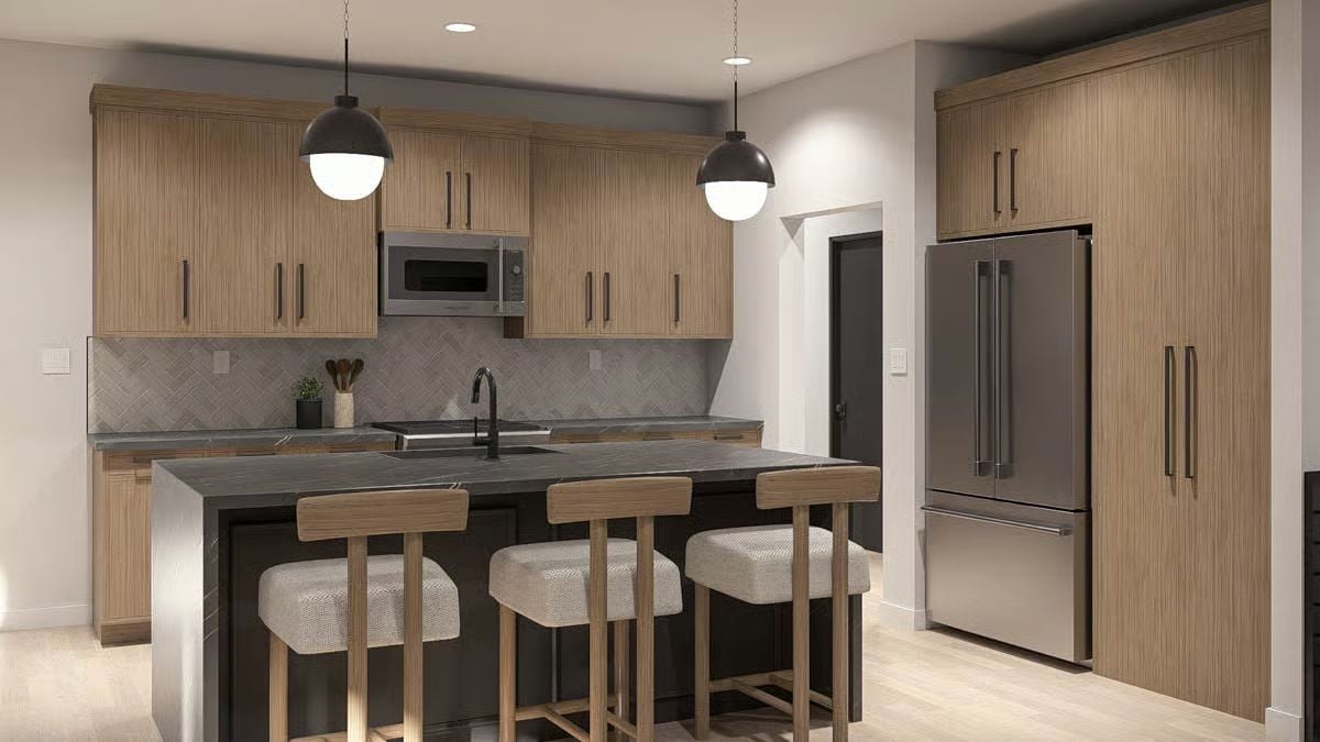 Warm Wood Cabinets and Dark Countertops Shape This Kitchen's Identity