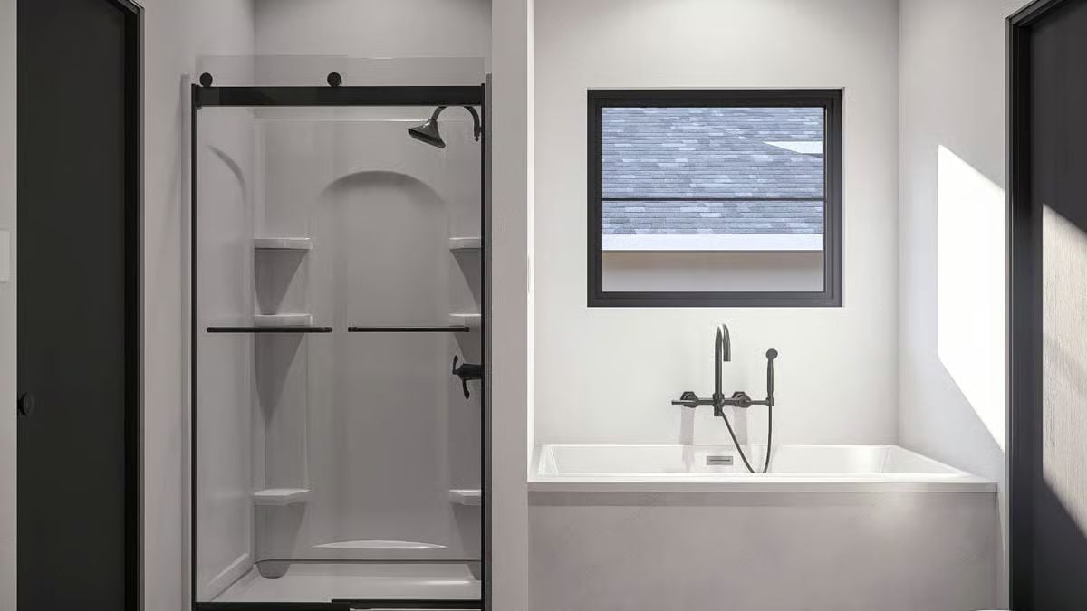 Matte Black Fixtures and Sliding Glass Door Define This Primary Bathroom
