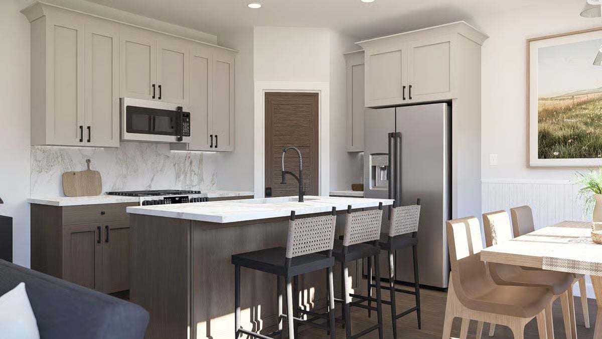 Woven Barstools and Marble Countertops Ground This Kitchen Island