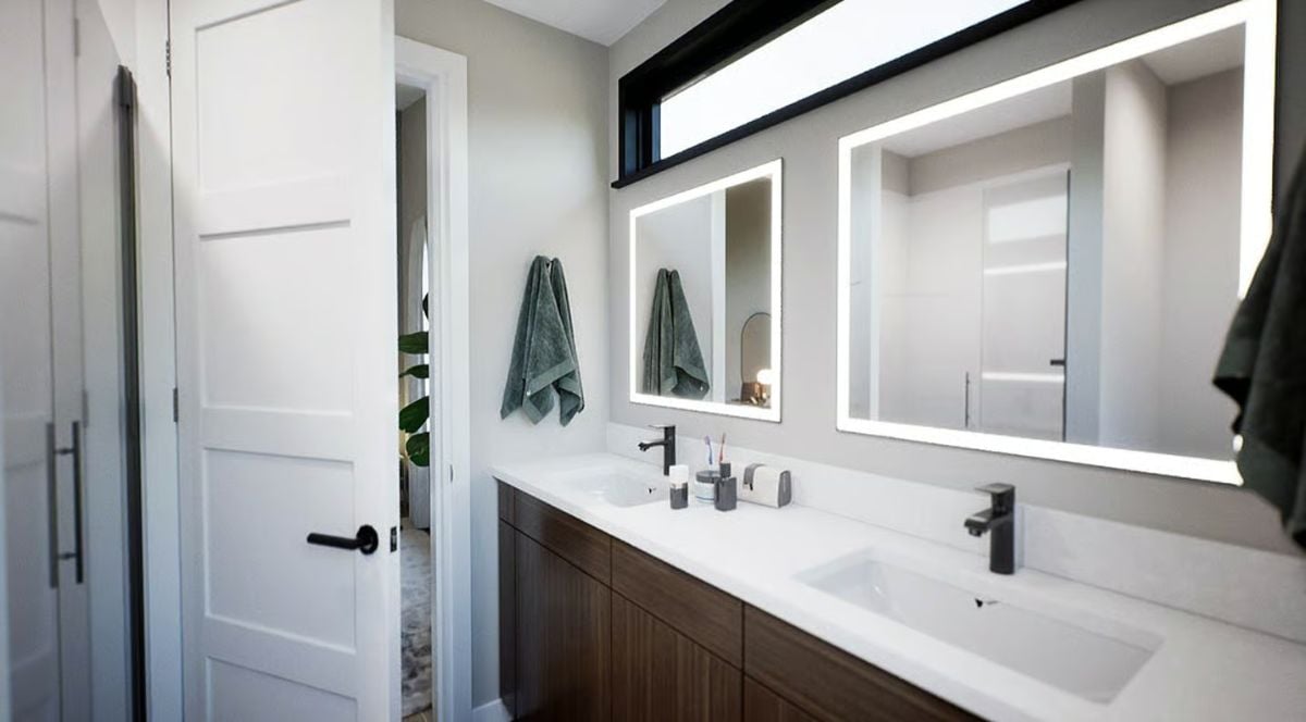 Backlit Mirrors and Matte Black Fixtures Shape a Double-Sink Vanity