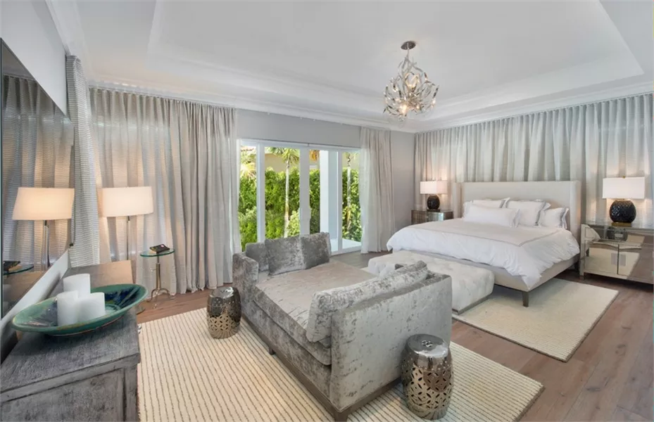 Crushed Velvet Chaise and Crystal Chandelier Set the Tone in This Primary Suite