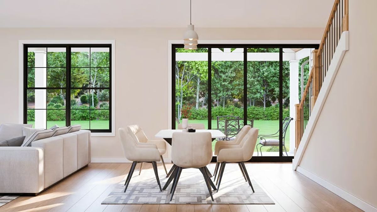 Dining Area with Black Steel Windows Overlooking Lush Garden Views