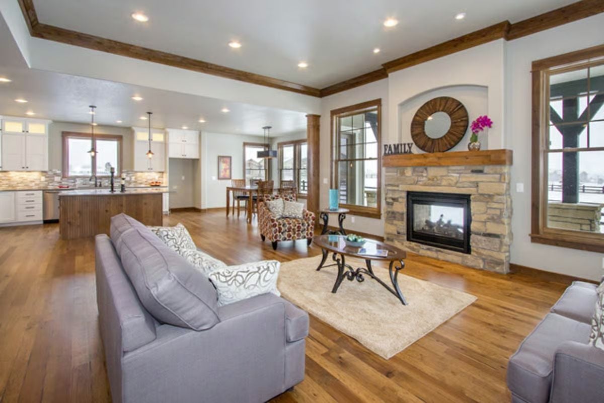 Stone Fireplace and Wood Ceiling Beams Anchor an Open-Concept Living Space
