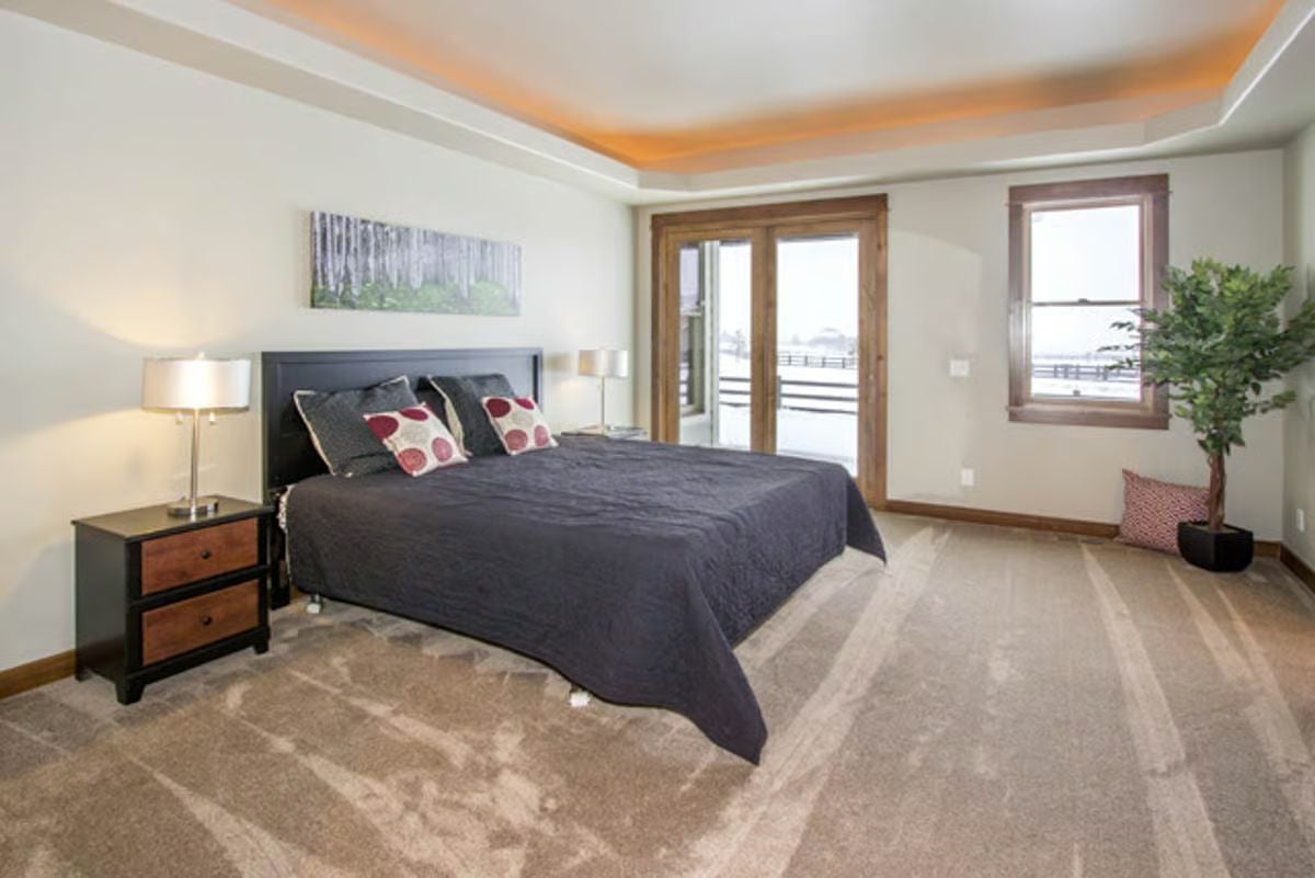 Tray Ceiling with Rope Lighting Crowns a Spacious Craftsman Master Bedroom