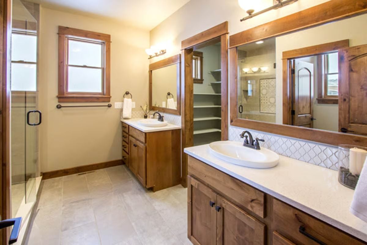 Double Vanities and Wood-Framed Mirrors Define a Craftsman Master Bath