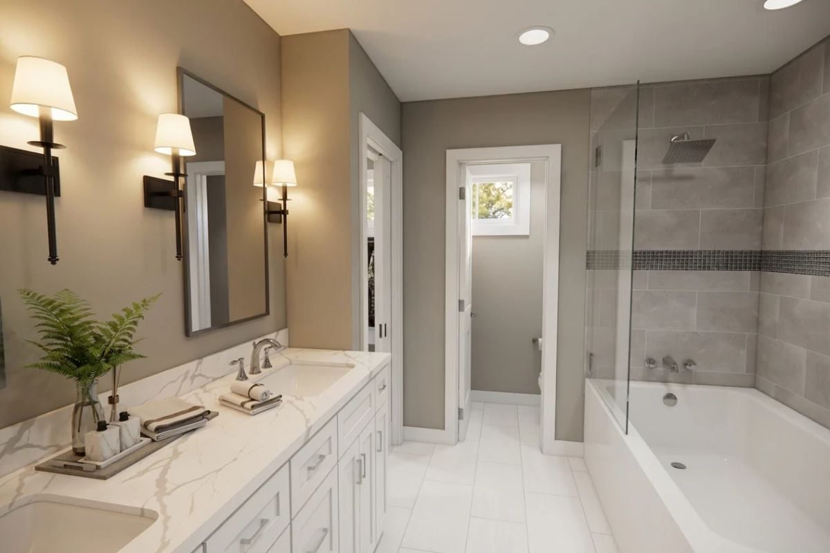 Marble Countertops and Wall Sconces Anchor a Double-Vanity Primary Bath