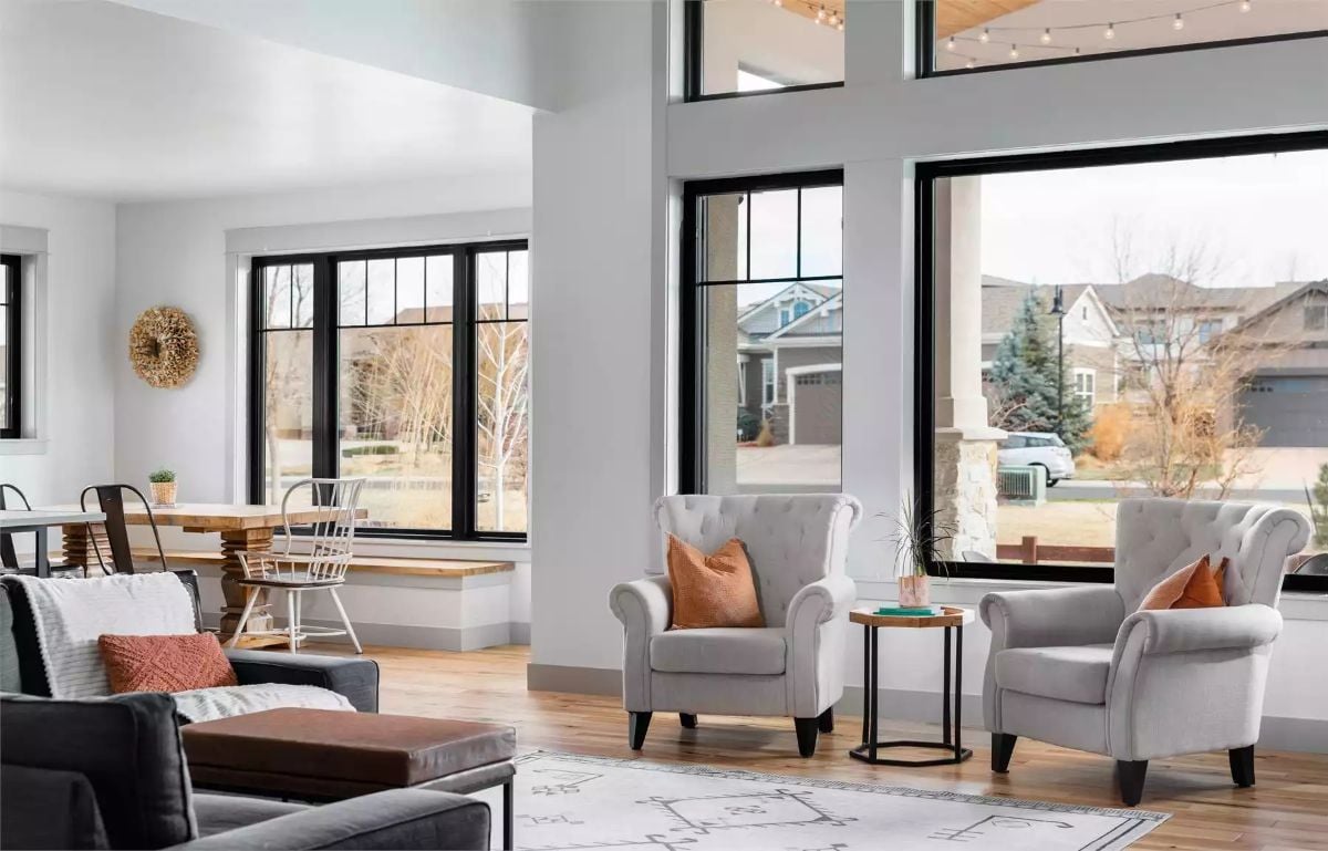 Tufted Chairs, Black Frames, and Light That Pours Through Every Wall