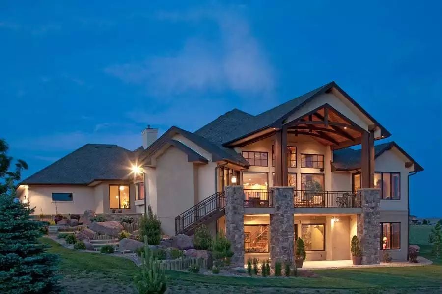 Craftsman Exterior Glows at Dusk with Stone Columns and Exposed Timber Gables