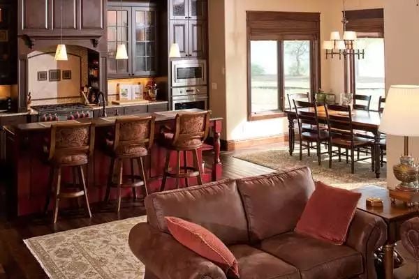 Leather, Wood, and Warm Light Define an Open-Plan Craftsman Gathering Space