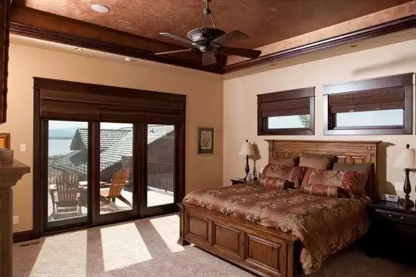Craftsman Master Suite Opens to a Waterfront Balcony Through Glass Doors