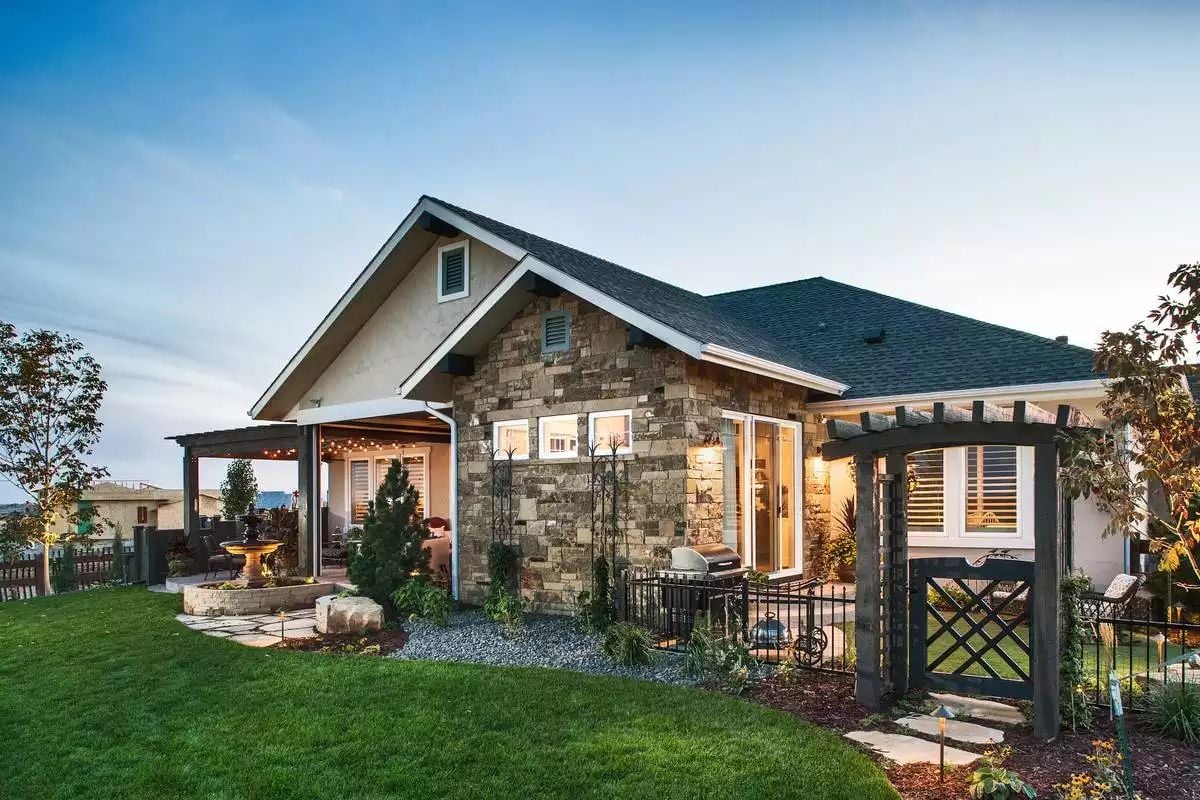 Stone Exterior and Covered Patio Define This Craftsman Backyard