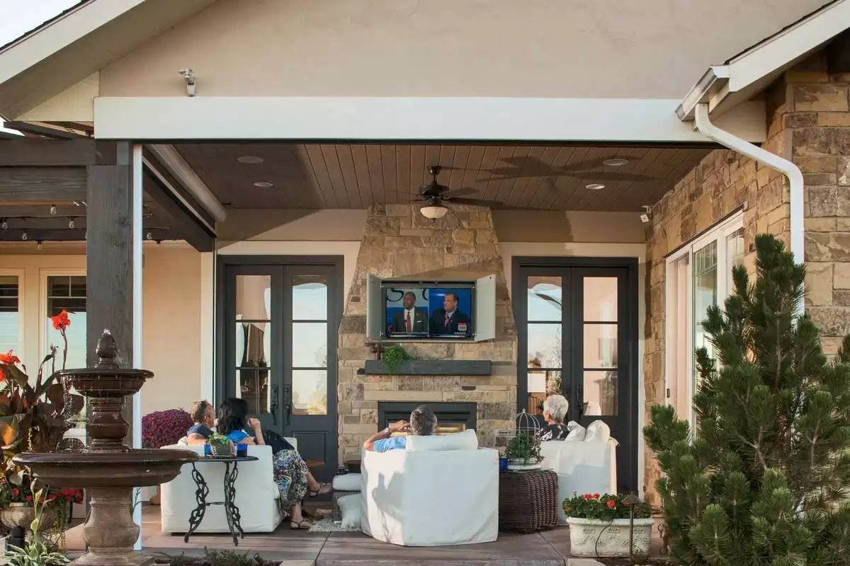 Covered Patio Fireplace and Outdoor TV Pull Guests Into the Open Air