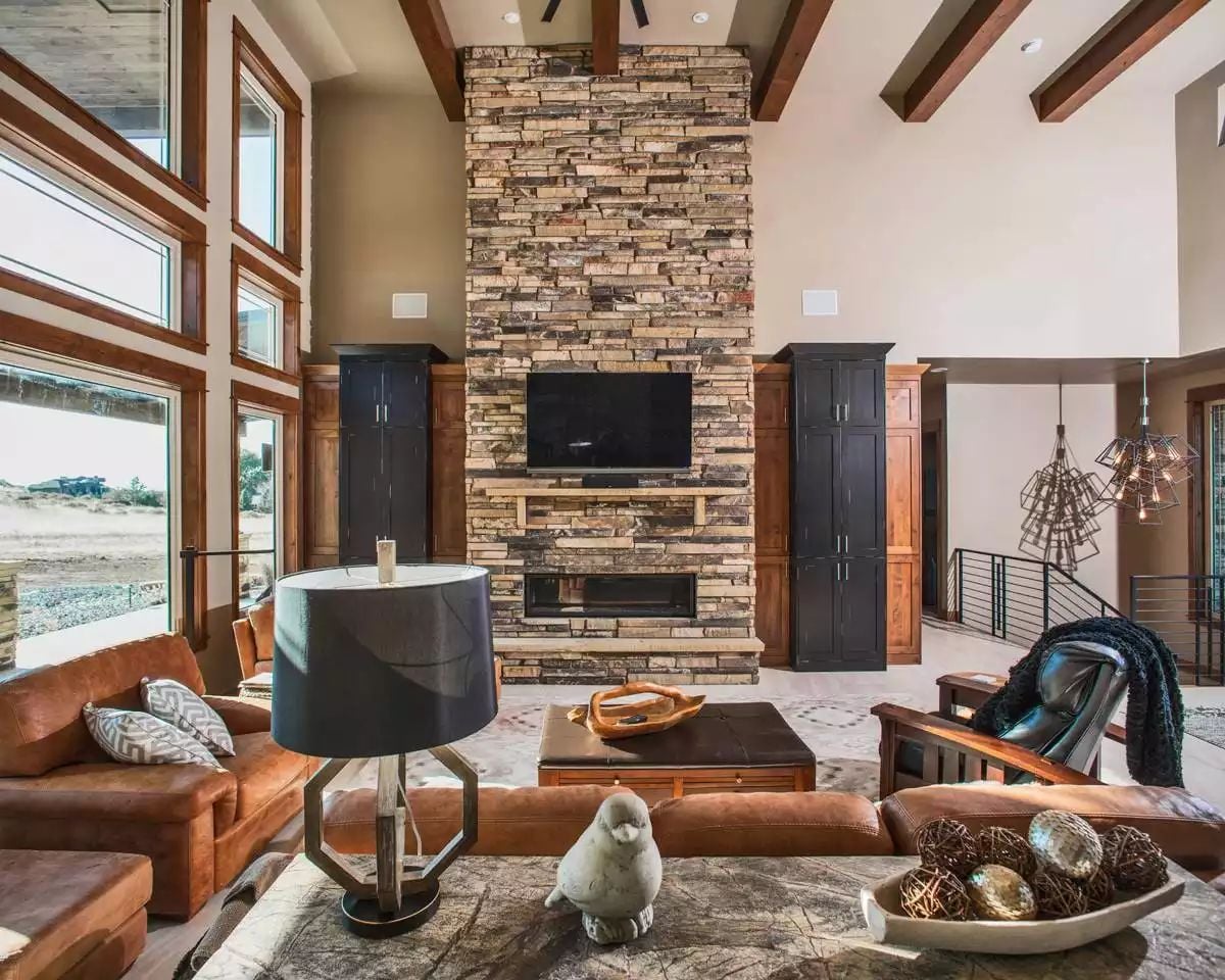 Stacked Stone Fireplace Anchors a Craftsman Living Room with Soaring Ceilings