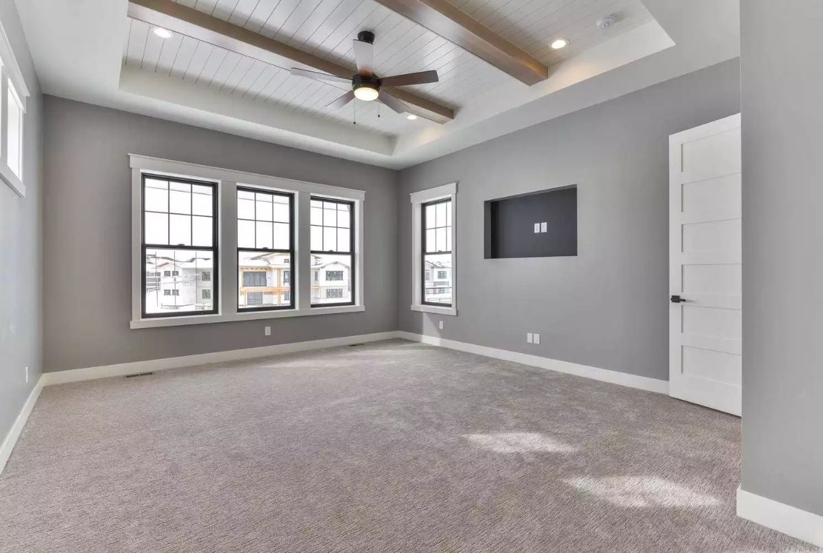 Coffered Ceiling with Wood Beams Defines a Spacious Master Suite