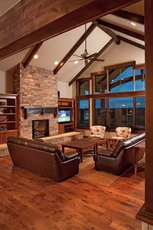 Vaulted Beams and Stone Fireplace Define a Craftsman Great Room