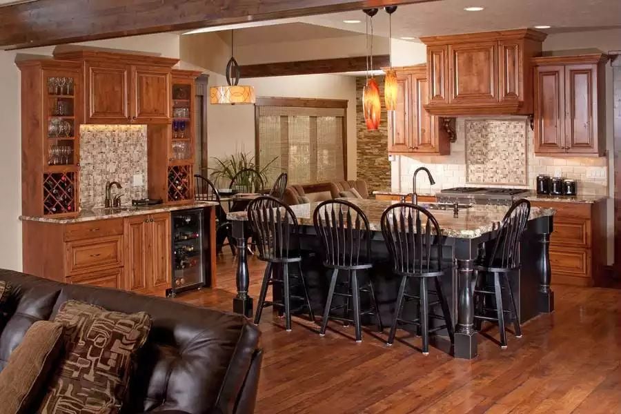 Warm Wood Cabinetry and a Black Island Anchor an Open Craftsman Kitchen