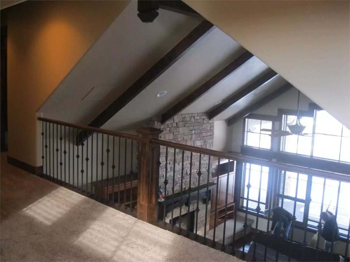 Loft Overlook with Iron Balusters and Vaulted Beam Ceiling