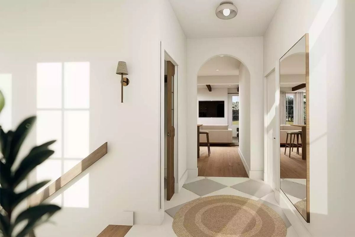 White Entry Hall with Arched Doorway and Natural Light