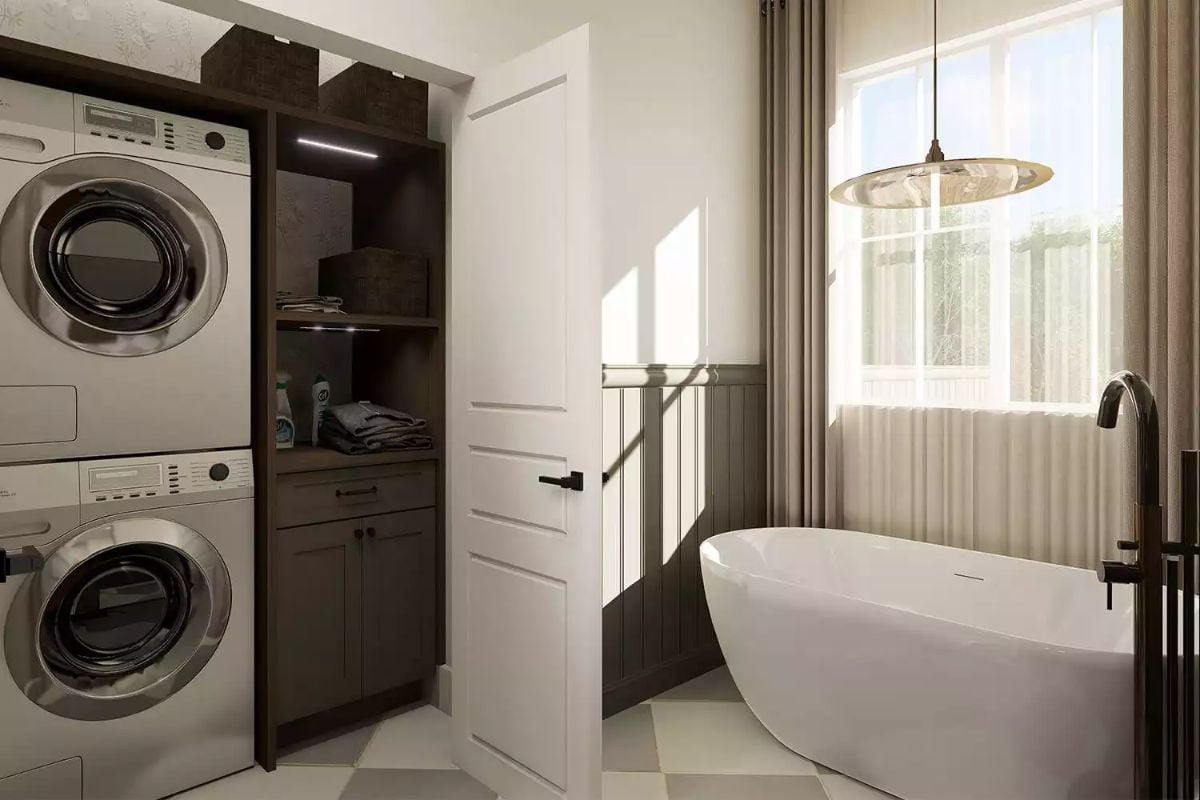Laundry and Bath Suite with Stacked Washers and Freestanding Soaking Tub
