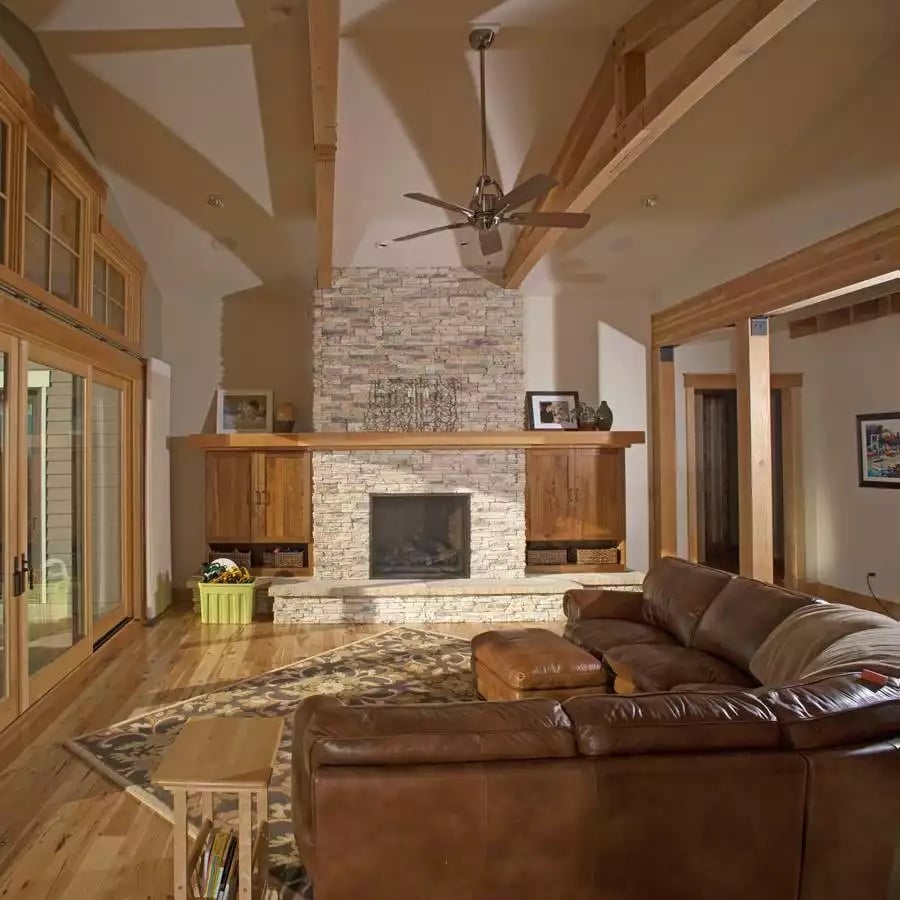 Stacked Stone Fireplace Anchors a Vaulted Great Room in Warm Wood Tones