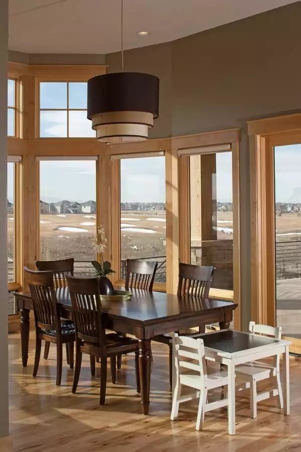 Dark Wood Dining Table Anchors a Sun-Filled Breakfast Nook with Panoramic Views
