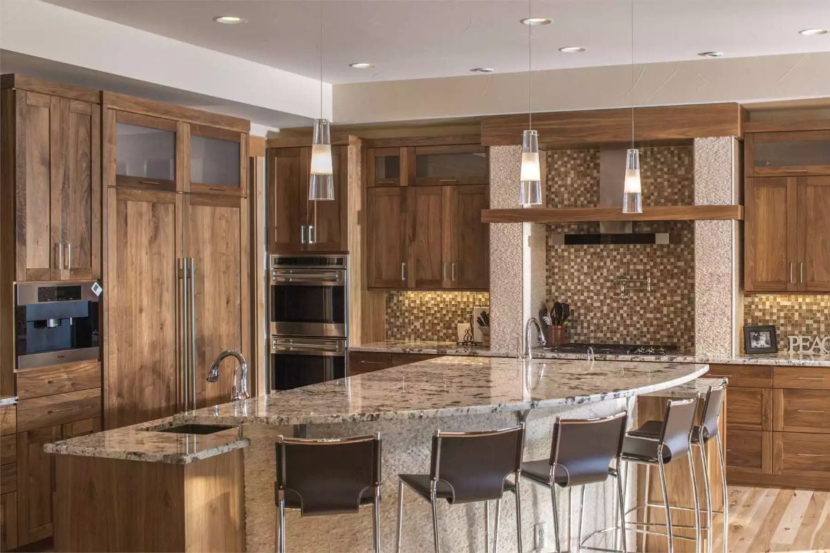 Granite Island Takes Center Stage in a Walnut Cabinet Kitchen Built for Entertaining