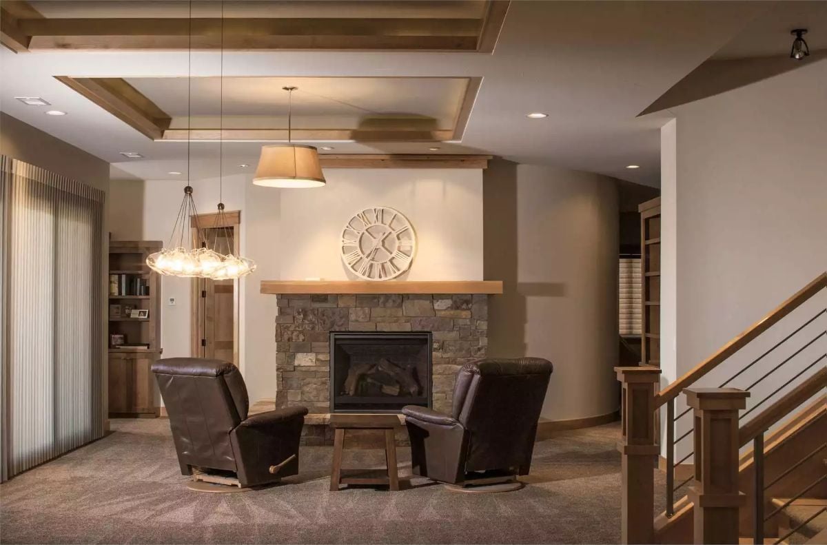 Leather Chairs and a Stone Fireplace Define a Lower-Level Sitting Room Built for Two