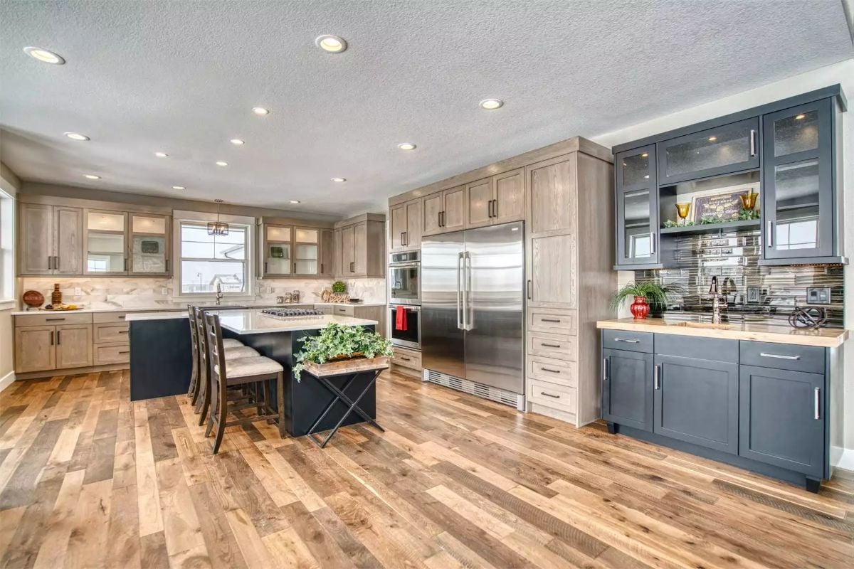 Gray and Wood Tones Meet Stainless Steel in a Spacious Kitchen