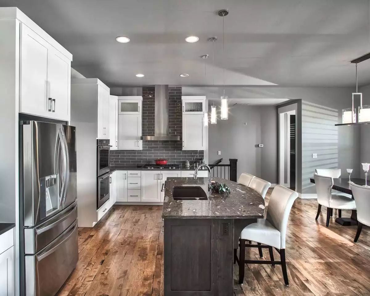 Granite Island and Dark Brick Backsplash Anchor a Kitchen Built for Cooking
